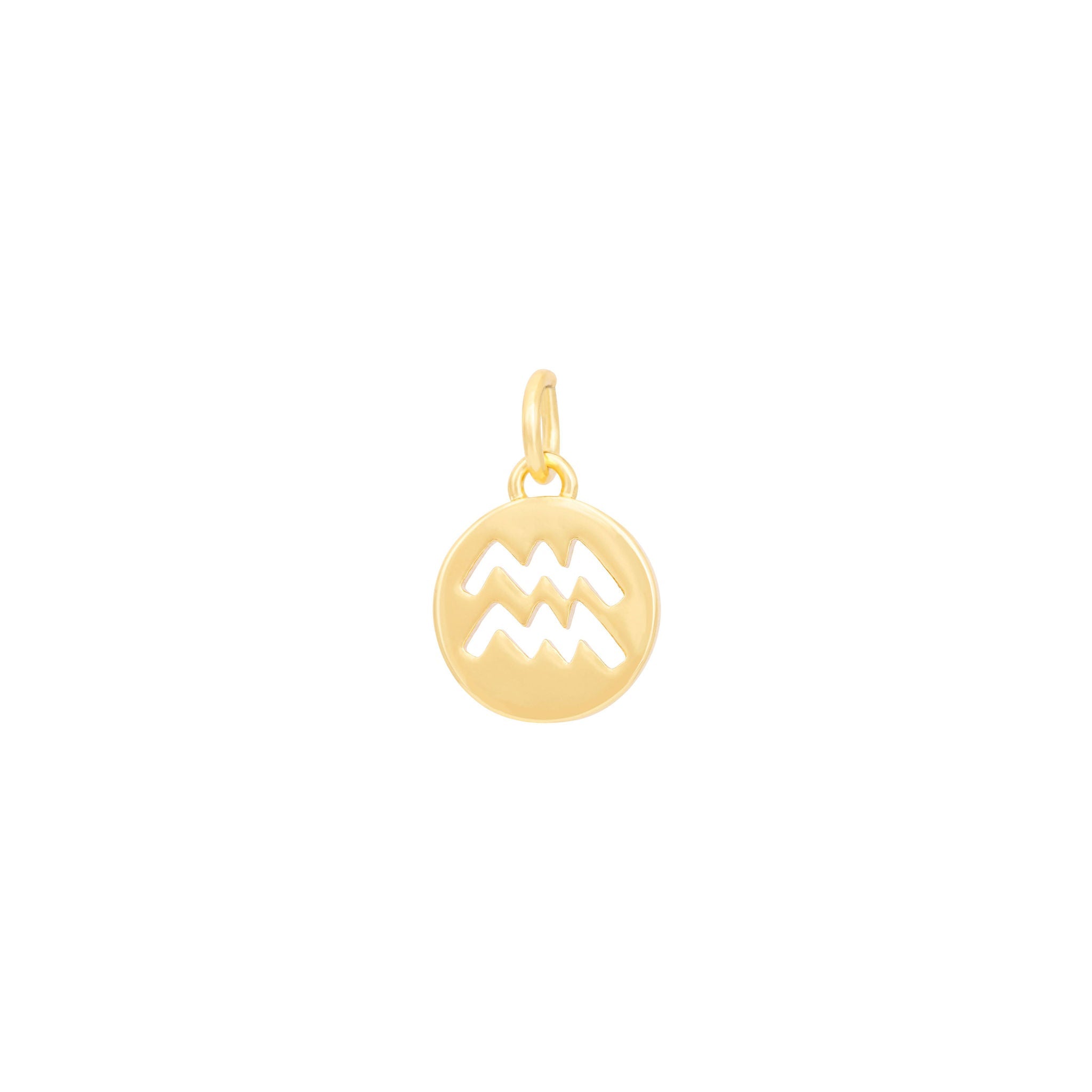 Introducing the Aquarius Charm - Gold by The Ends, a stunning circular pendant beautifully crafted with a hollowed-out Aquarius zodiac sign symbol, featuring two parallel zigzag lines. Part of our curated collection of standard charms, this exquisite piece includes a small loop at the top for easy attachment to a necklace or bracelet. The product image is set against a clean white background.