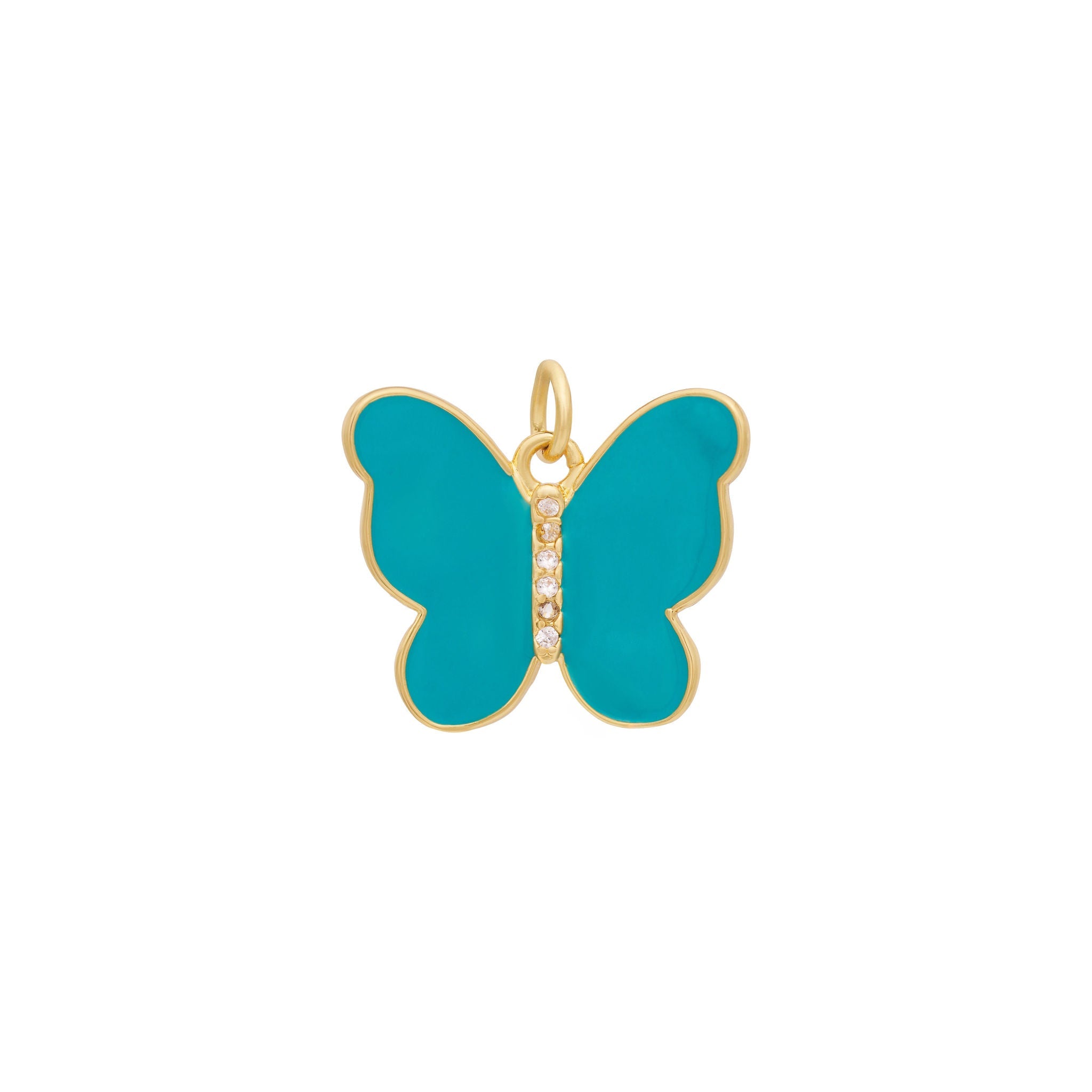 Introducing the Enamel Butterfly Charm by The Ends in stunning pink, featuring a gold border and light pink wings. At its center, a vertical row of small, sparkling zircon stones adds a touch of elegance. Complete with a small gold ring at the top for easy attachment to chains or bracelets, this charm stands out as one of the most refined options available.