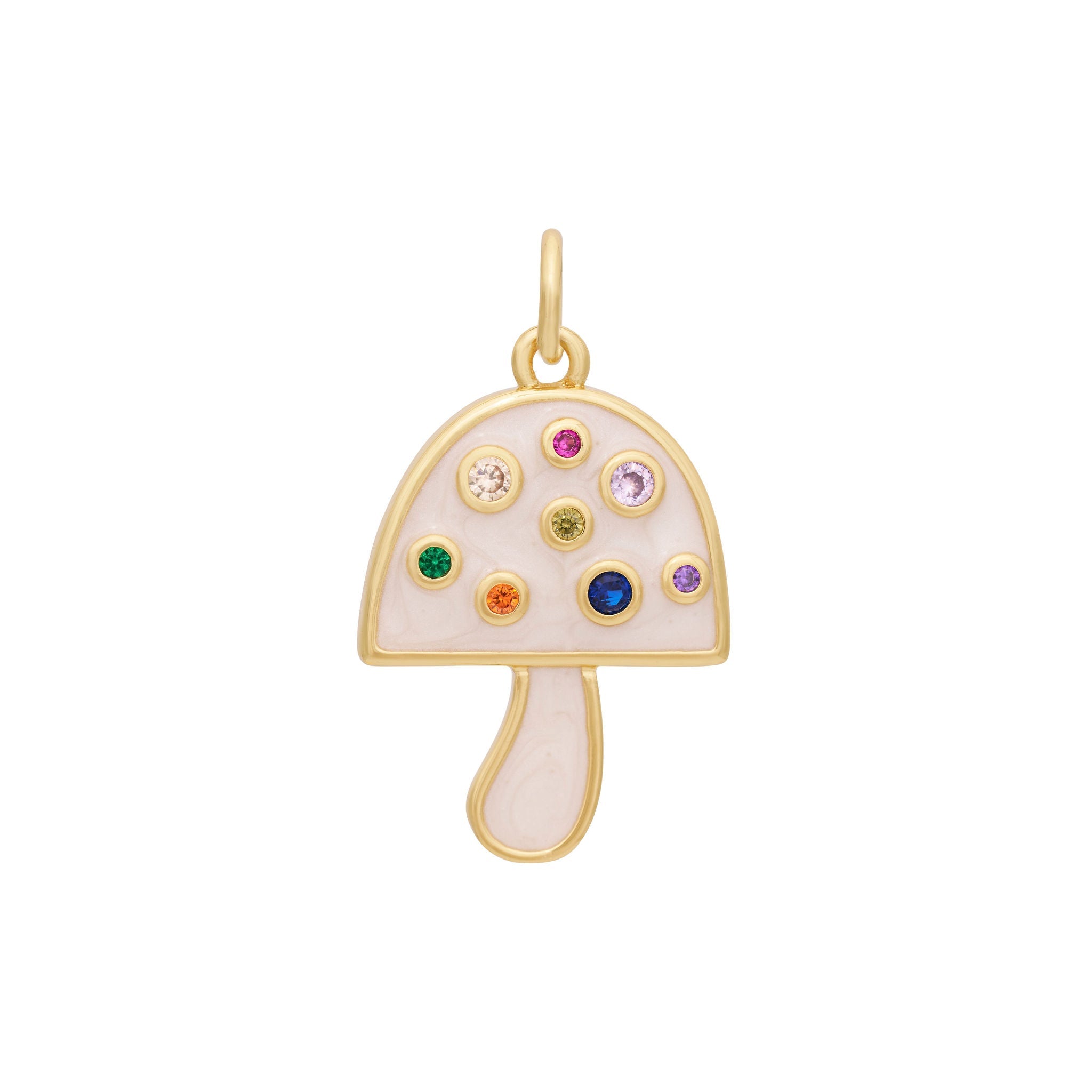 The Enamel Mushroom Charm - Gold by The Ends is a charming accessory featuring colorful gemstones in various sizes on the cap. The mushroom’s body and stem are gold, accentuated with a touch of pastel pink. This delightful charm also includes a circular loop at the top, allowing you to attach it to any The Ends with ease.