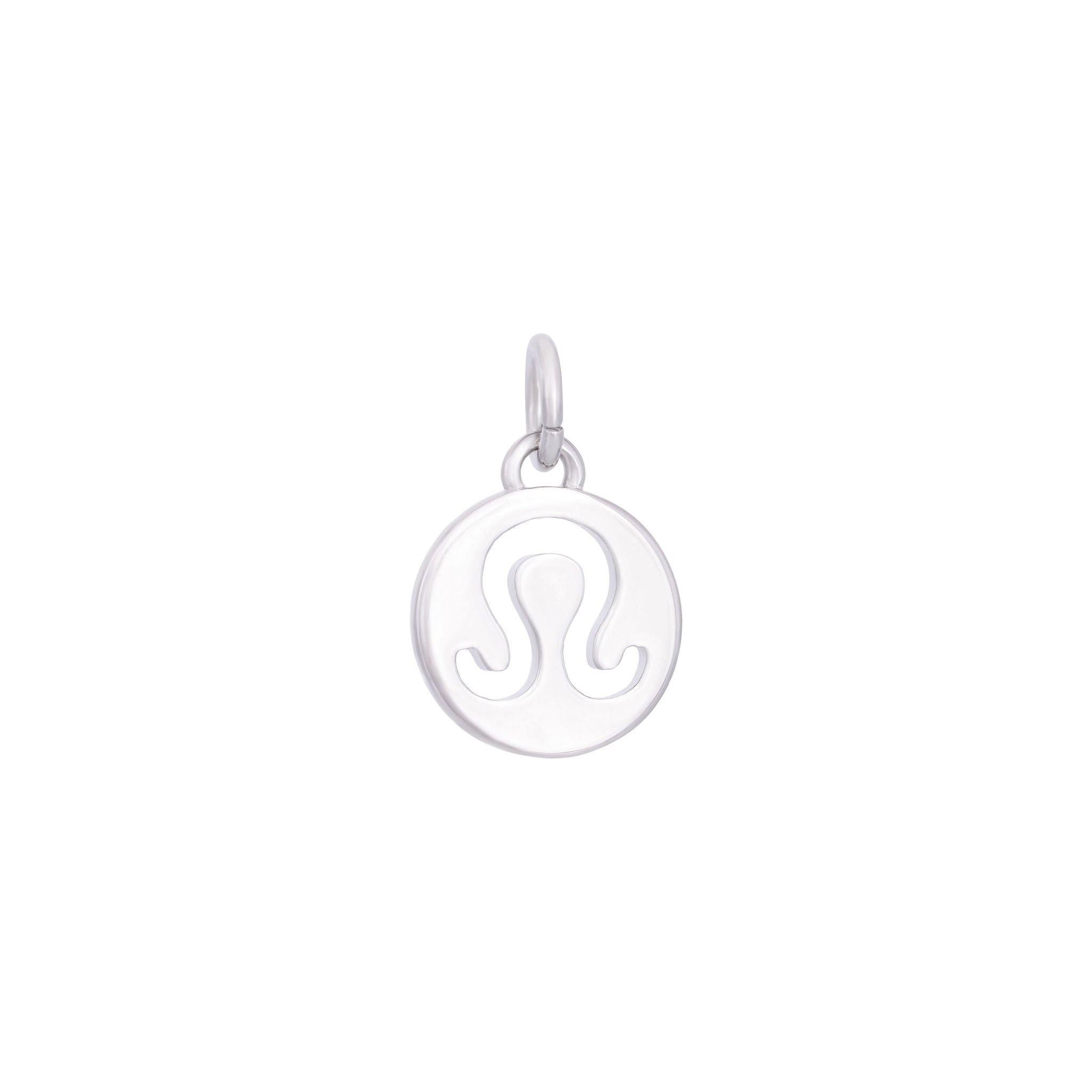 The Leo Charm - Silver, by The Ends, is a small, round pendant with a polished silver finish. It features a stylized 'A' shape with extended legs hanging from a circular loop. This sleek medallion charm makes a subtle yet captivating statement.